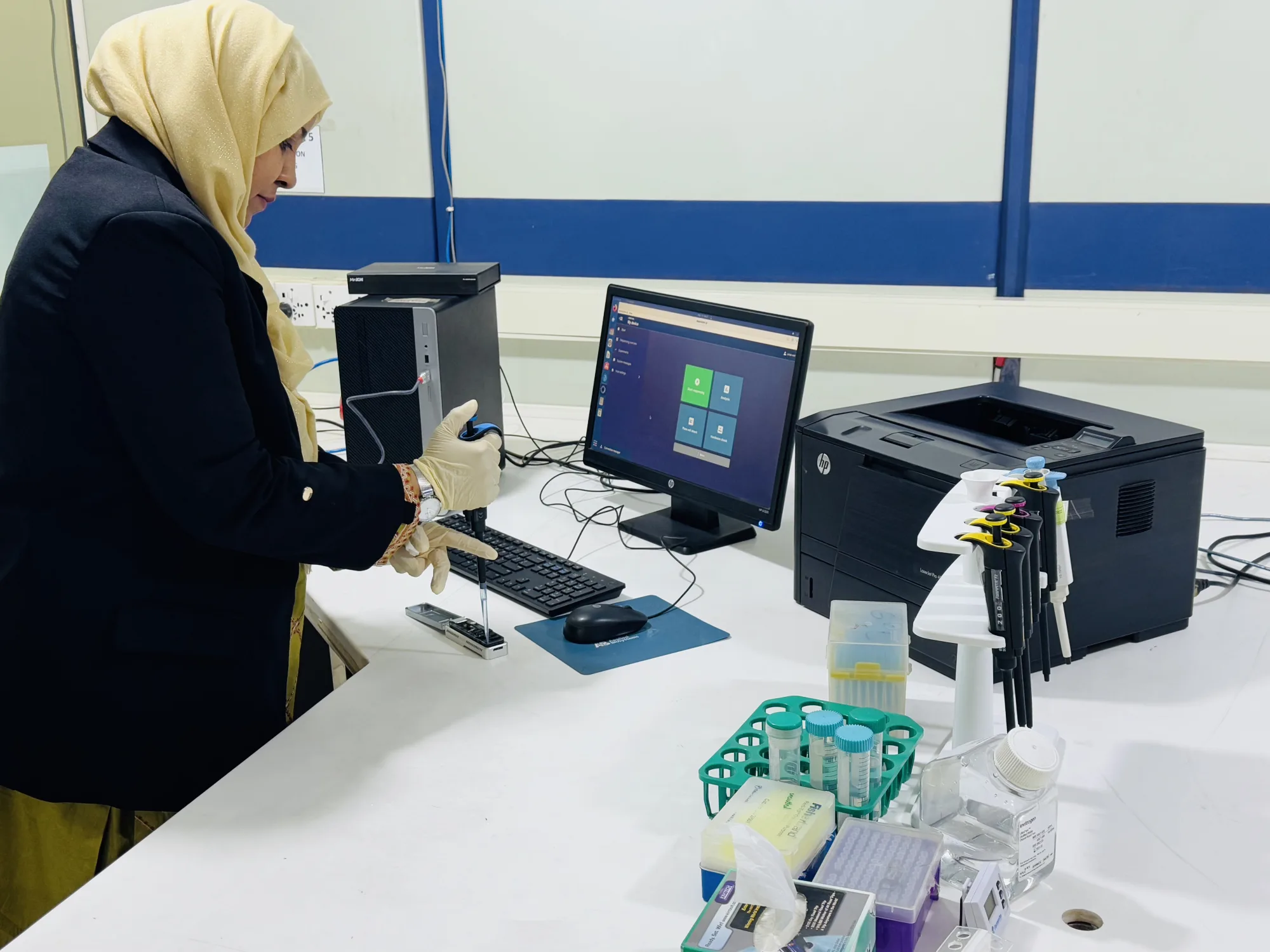 CEMB researcher operating a laboratory analyzer