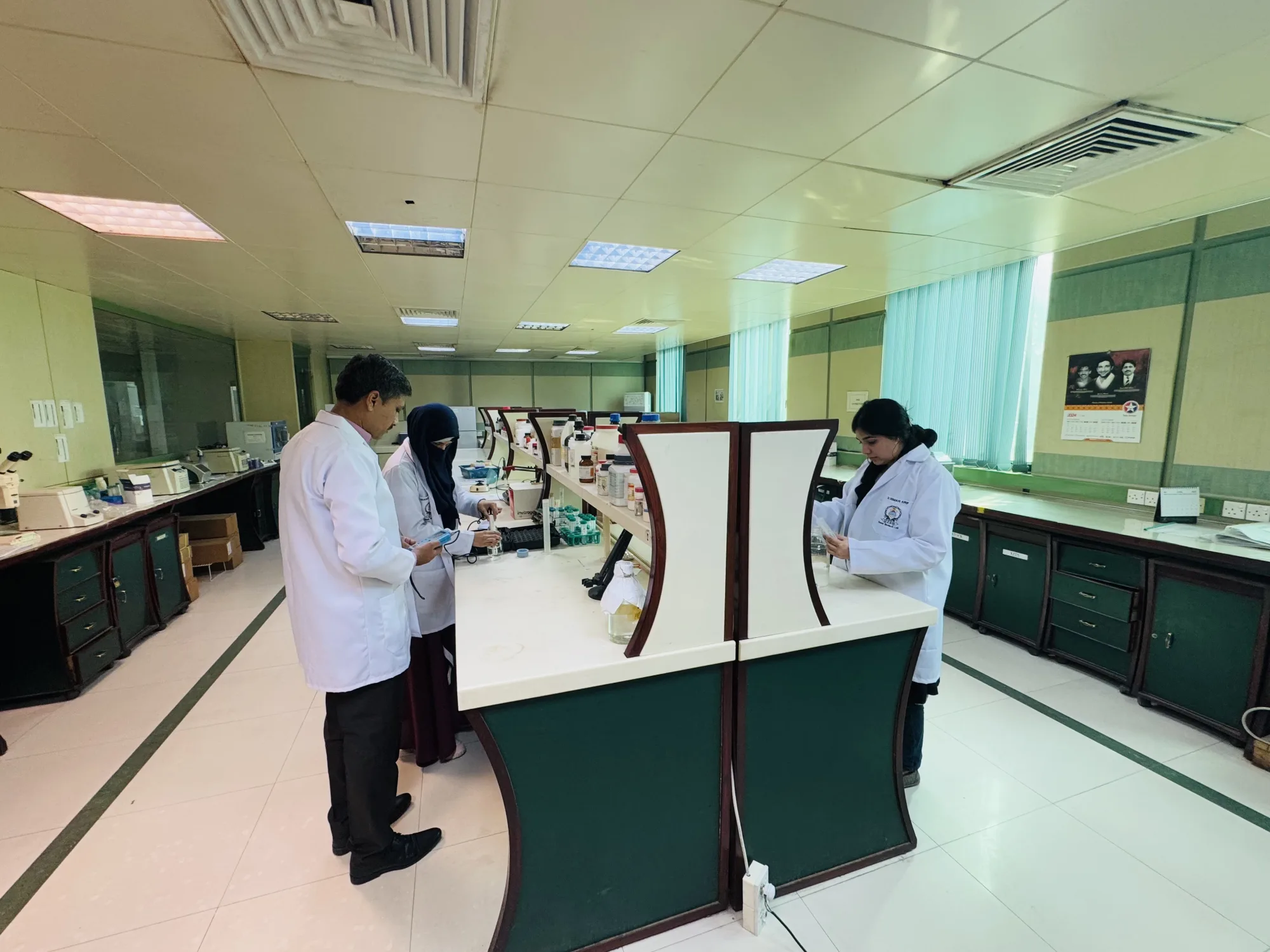CEMB scientists collaborating around a laboratory bench